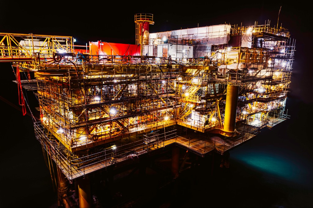 Offshore industrial platform illuminated at night